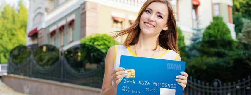 woman holding big banking card