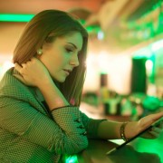 young woman reading facebook on a digital tablet in cafe