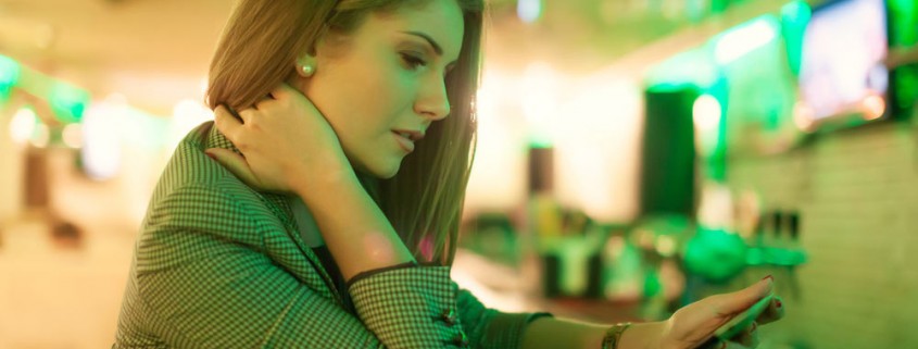 young woman reading facebook on a digital tablet in cafe