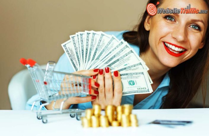 Young smiling woman holding cash